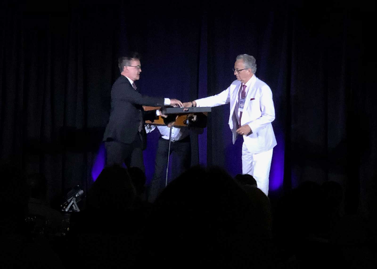 David Sandy and Lance Rich perform The Great Leon's Pillory Escape Illusion at the Magic Collectors Expo 2021