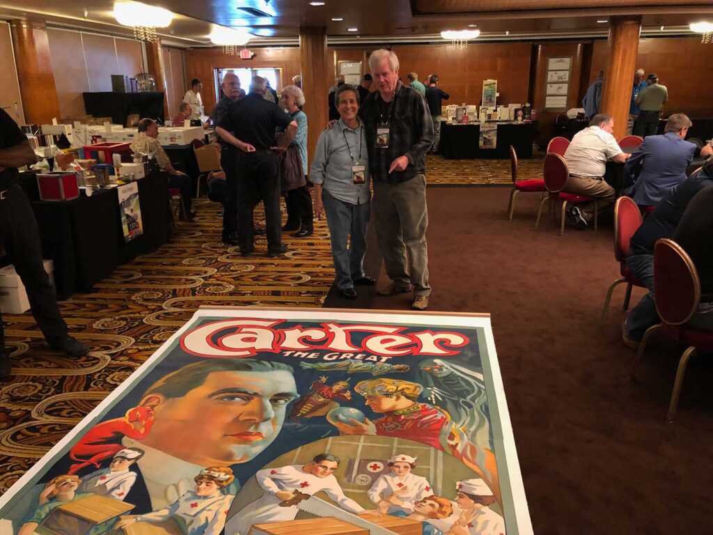 Lupe Nielsen with Mike Caveney and an 8-sheet magic poster of Carter the Great magician